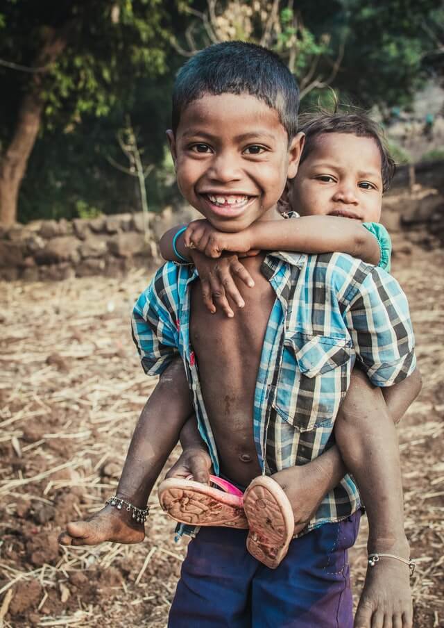 Boy Carrying A Child 1427430